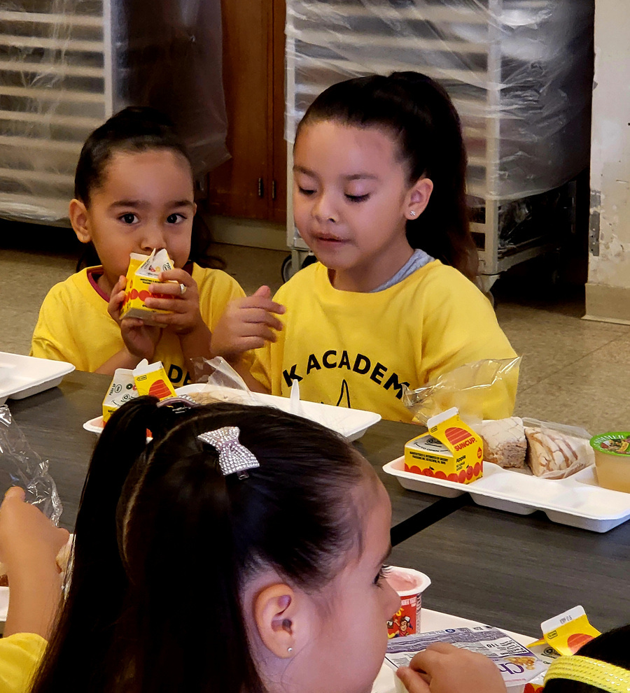 TK Academy students eating a snack together at a table
