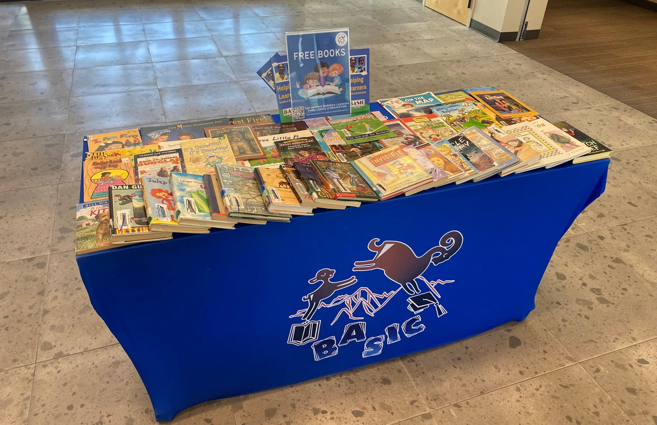 A BASIC free-books table stocked with children&rsquo;s books in a community building lobby
