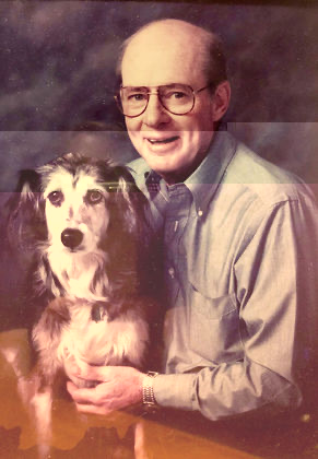 A formal portrait of Bill Wright seated with his dog on his lap