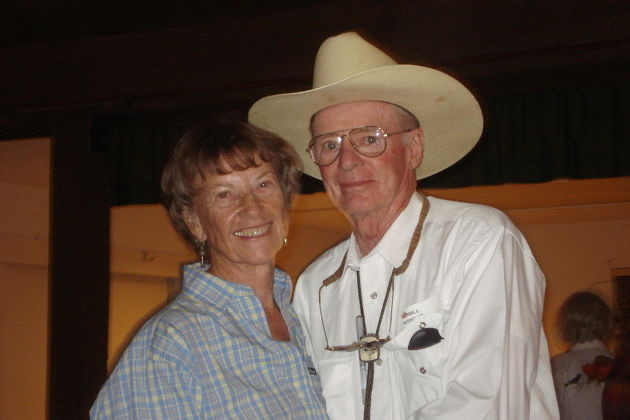 Bill and Jenny Wright in cowboy hats, smiling together
