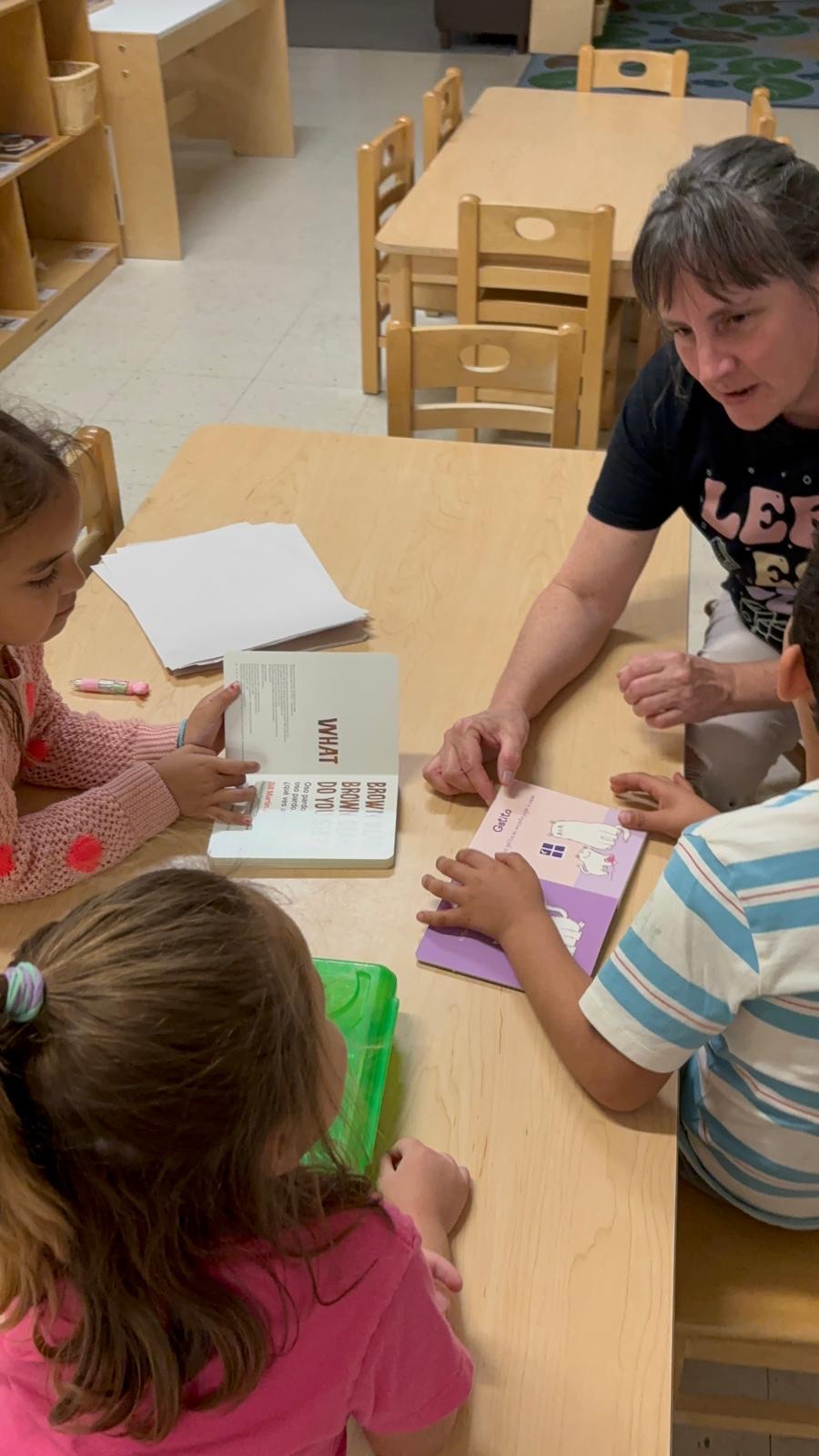Parents and children working together at a table during a family literacy session