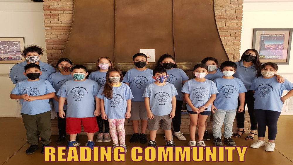Learning Academy students in matching blue shirts and masks lined up in front of a fireplace under the words Reading Community